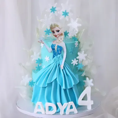Let it go with this magical "Frozen" themed cake for a fourth birthday. This design features a beautiful Elsa figure in her iconic blue dress, surrounded by delicate, edible snowflakes and ice shards.
