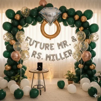 This is a complete engagement party setup I designed, featuring a lush balloon arch in an elegant green and gold theme. I included custom foil balloons for the couple's name and a large diamond ring balloon to create a perfect photo backdrop for their special announcement.