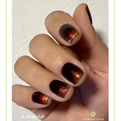 A chic and moody manicure featuring a dark brown to burnt orange ombre effect with a subtle metallic shimmer, perfect for an autumn look.