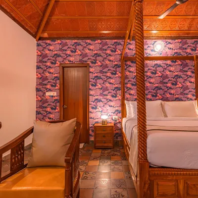 This is a bedroom I designed for Brown Town Resorts in Hyderabad, embracing a timeless earthy aesthetic. The four-poster bed, patterned floor tiles, and bold wallpaper create a space that feels both traditional and luxurious.
