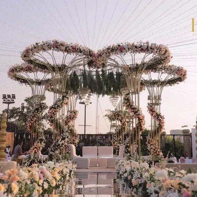 A fairytale mandap designed with heart-shaped floral arches in soft pastels, creating a truly romantic and grand centerpiece for an outdoor wedding.