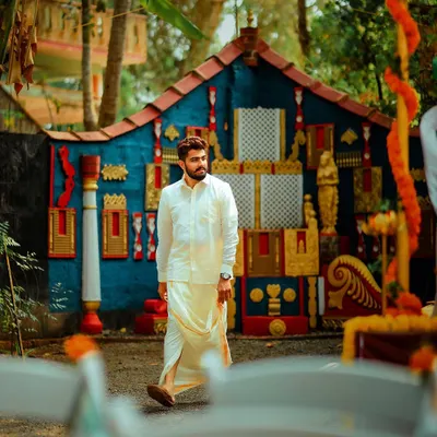 A portrait of the groom, Vivek, at his Mantra Mangalya wedding in Mangalore. The setting is natural and vibrant, reflecting the unique, open-air nature of this special ceremony.