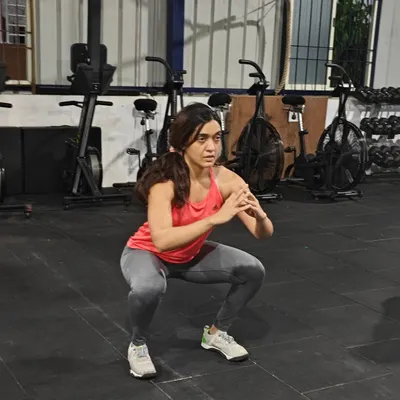 This workout challenged muscular stamina with static holds. Here, a member demonstrates a perfect squat hold, building isometric strength and mental toughness.