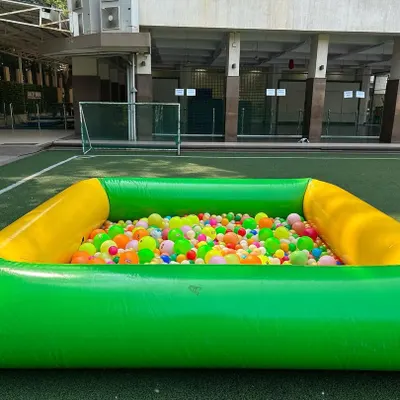 My large green and yellow inflatable ball pit, ready for fun. It comes filled with hundreds of clean, multi-colored plastic balls.