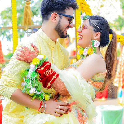 The pure, unscripted joy of a Haldi ceremony. This candid shot of the couple sharing a laugh is what we love to capture, preserving the genuine happiness and playful spirit of the day.