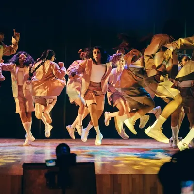 The energy in the air is electric as our dancers take flight. This mid-air shot from Performance Night captures the explosive power and synchronization of our crew.