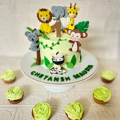 This jungle-themed cake is covered in our handmade fondant animals. We sculpted a friendly lion, elephant, giraffe, koala, monkey, and zebra to create a wild first birthday celebration.