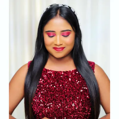 This is a perfect example of a cocktail party look. The focus is on the vibrant pink eyeshadow and glowing skin, paired with a sequined red dress for a fun and glamorous feel. The hair is styled sleek and straight with a simple headband.