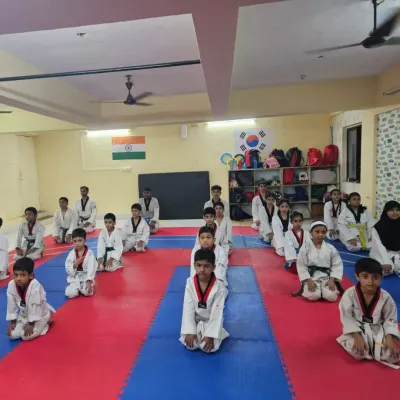 A moment of calm and focus. Our students kneel in formation, showing the discipline and respect that is central to our teaching philosophy.