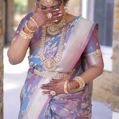 A candid, emotional moment from a wedding day. Our full temple jewellery set, including the intricate kambarpatta and bajuband, added to her stunning bridal glow.