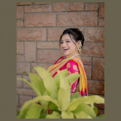 A beautiful, happy portrait of a Maharashtrian bride, with her smile lighting up the frame. A perfect candid moment captured.