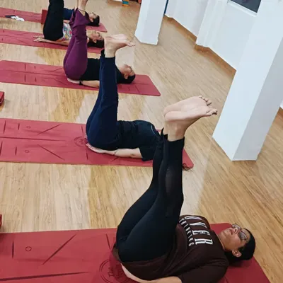 Students practicing Urdhva Prasarita Padasana (Upward Extended Feet Pose), an excellent asana for strengthening the core and lower abdominal muscles.