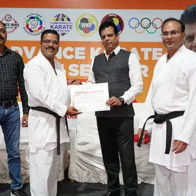 Presenting a certificate at the conclusion of an Advance Karate Kumite Seminar in Pune, Maharashtra. Continuous education for athletes and coaches is a top priority.