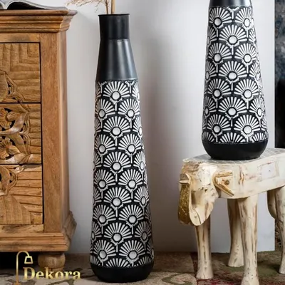 This set of two tall metal vases features a striking black and white geometric fan pattern. They are perfect as floor vases to add a bold, graphic element to your living space or entryway.