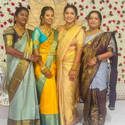 A beautiful family portrait from a wedding celebration. Our client Geeta (in gold) and her sisters and cousins are all draped in the regal artistry of Mathura Creations sarees.
