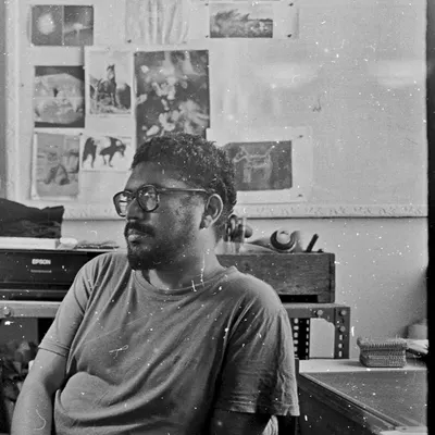 A candid portrait taken on black and white film, showing our darkroom manager Krishanu in the studio. There's a certain character and texture to film grain that digital can't replicate.