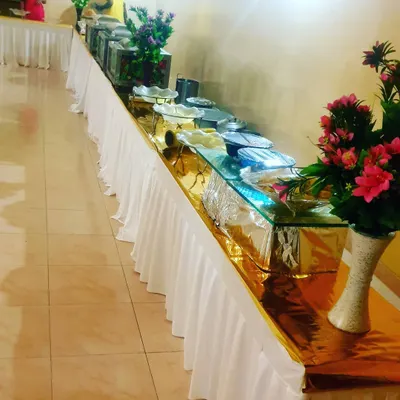 A straightforward and clean buffet line for a smaller corporate gathering. This setup is functional and efficient, perfect for office lunches or internal meetings.