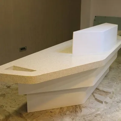 This custom-designed reception table for the Hotel Priyadarshini in Hospet features a futuristic, layered form. Its sculptural quality makes a strong first impression, setting a modern and sophisticated tone for the entire establishment.