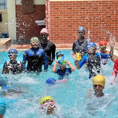 A snapshot of the energy and fun from one of our regular swimming classes. You can see our coaches right in the water with the kids, making a splash and learning together.
