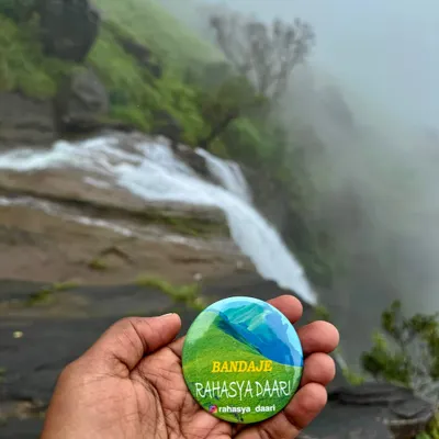 My custom "Bandaje Rahasya Daari" badge against the backdrop of the falls. I love creating little souvenirs to make your trip extra special.