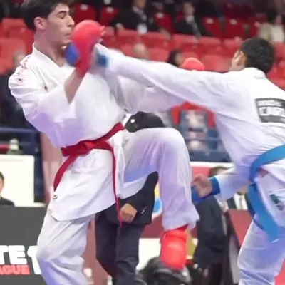 A clear, high-impact shot of a head kick connecting during a competitive match. This demonstrates the precision required to score an Ippon (full point) in sport karate.