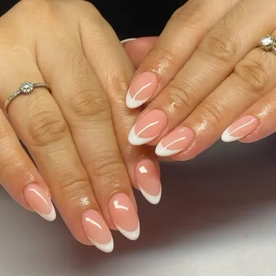A perfect example of classic almond-shaped French manicure. The clean white tips and natural pink base are ideal for a sophisticated, everyday look.