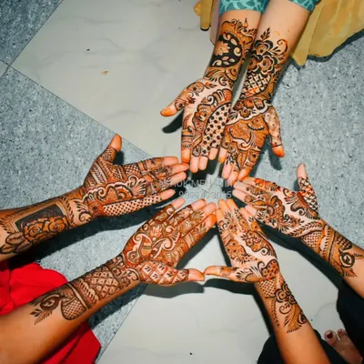 A beautiful shot of a group of friends showing off their coordinated mehndi designs. I love working with groups to create patterns that are similar in style but unique to each person.
