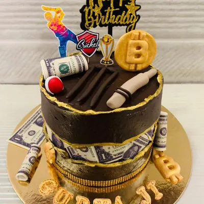 When cricket and Bitcoin are life! This unique two-tiered chocolate cake combines two passions, featuring edible money, a Bitcoin symbol, and cricket-themed fondant toppers.