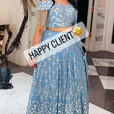 A happy client looking stunning in a powder blue lehenga with silver embroidery. Her smile says it all.