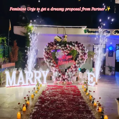 This is what the beginning of forever looks like. I helped create this magical proposal with a heart made of balloons, a path of soft rose petals, and glowing "MARRY ME" letters. The finishing touch of cold pyros made the moment truly unforgettable.