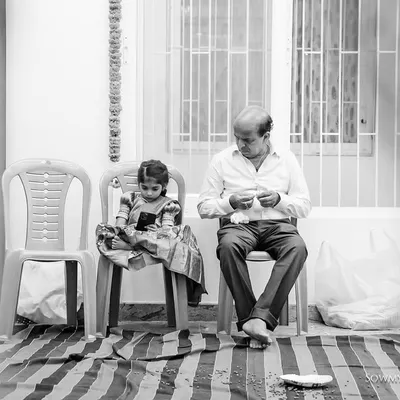 A quiet, beautifully framed black and white shot of a grandfather and granddaughter sitting together. We are always watching for these simple, slice-of-life moments that tell a deeper story.