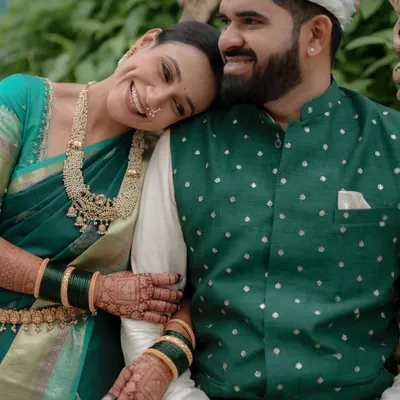 A heartwarming moment between a happy couple during their engagement. I styled the bride in a beautiful teal green saree with traditional gold jewelry, and the groom in a coordinating green jacket, creating a harmonious and elegant look.