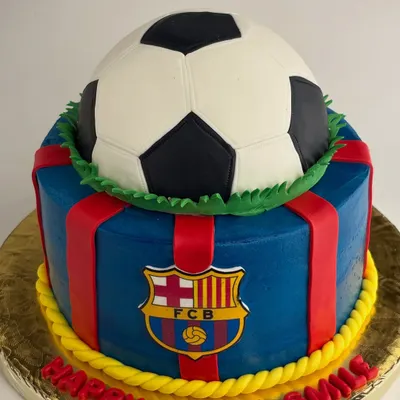 A bold FC Barcelona themed cake to celebrate a football fan's birthday. This design features the club's crest and colors, topped with a realistic football piñata.