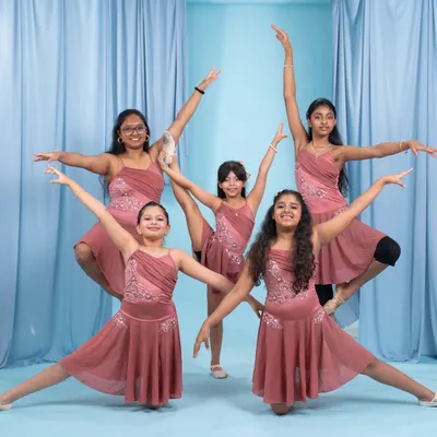 Our talented young dancers striking a pose in their beautiful costumes. We focus on grace, technique, and teamwork in our kids' contemporary and jazz classes.