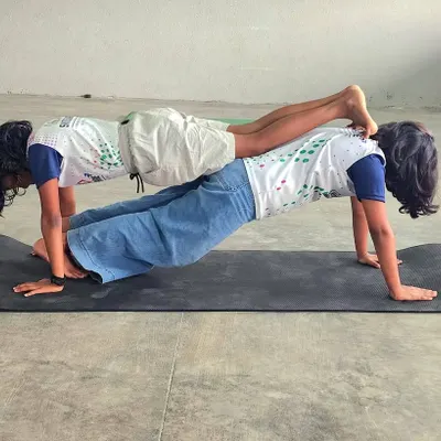 This partner plank is a fantastic exercise for building core strength and endurance. It requires both children to work together, synchronizing their stability and focus.