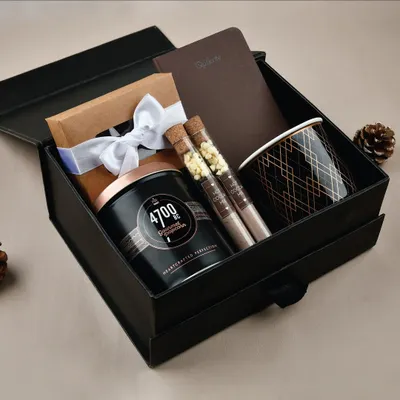 Our "Cozy Vibes" gift hamper, featuring gourmet popcorn, hot chocolate test tubes, a notebook, and a stylish mug.