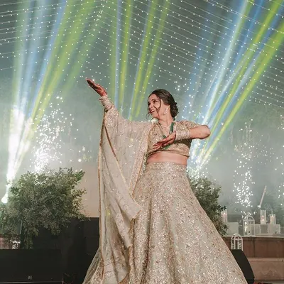 A stunning solo performance by the bride, captured perfectly against a backdrop of cold fireworks. We choreographed this piece to be elegant and powerful, giving her a true star moment on her sangeet night.