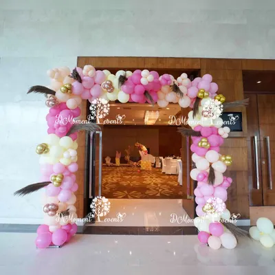 We designed this welcoming entrance arch for a baby's Annaprashan ceremony, marking their first taste of solid food. The boho-themed balloon arch in shades of pink, white, and gold is accented with pampas grass feathers, setting a warm and celebratory tone.