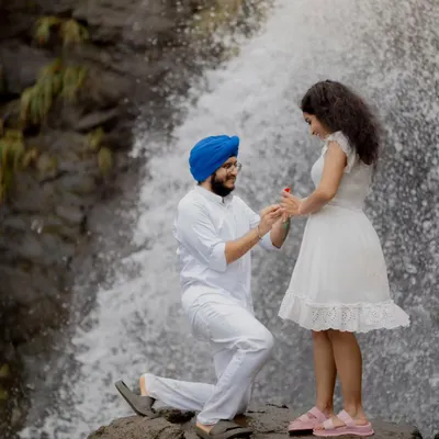 A perfect proposal moment captured during a pre-wedding shoot at a breathtaking waterfall. These sessions are ideal for telling your story in a unique, natural environment.