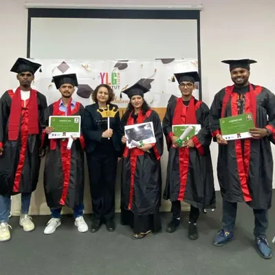 A group of our recent graduates in their ceremonial gowns, proudly holding their hard-earned certificates. They are now certified professionals ready for the industry.
