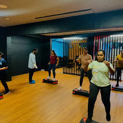 A full view of our step aerobics group session. Everyone is focused and moving together, creating a motivating and high-energy atmosphere.