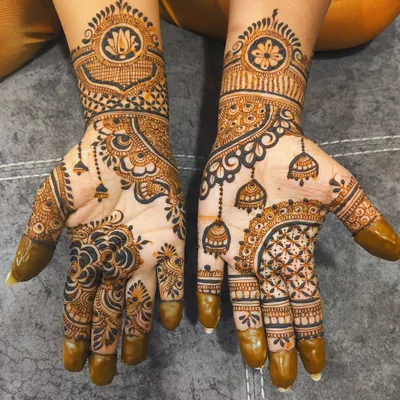 This Diwali design is full of festive details, featuring hanging jhumkas and lotus motifs. The mix of bold, dark elements and delicate patterns creates a balanced and eye-catching look perfect for the festival of lights.