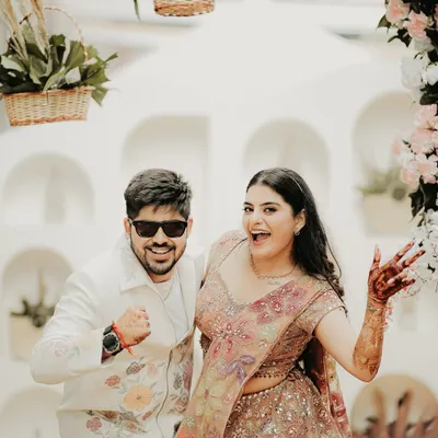 Pure fun and energy. This shot captures the couple's playful side during their pre-wedding festivities, their expressions full of excitement and joy.