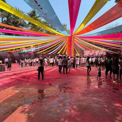 A wide-angle view of the 'Rang De' Holi party setup at Shivaji Park. You can see the scale of the multi-colored fabric draping that created a festive canopy over the entire ground, accommodating a houseful crowd.