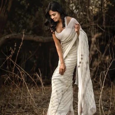 This image from a shoot in a natural setting captures a candid, gentle moment. The model's downward glance and the soft focus of the background create a serene and thoughtful mood, perfect for a lifestyle portrait series.