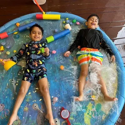 Pure summer joy! These two are having the best time splashing around on the water mat during our Holi week celebrations. It’s all about carefree fun and making happy memories.