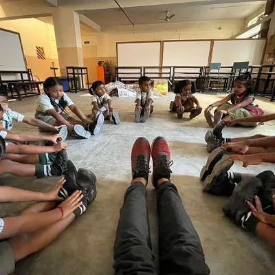 From my perspective, leading a flexibility game where students stretch to touch their toes. This group stretching activity helps improve hamstring and lower back flexibility while fostering a sense of unity.