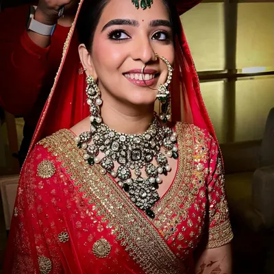 A radiant smile on my beautiful bride Sanya. Her look was centered around deep kohl-rimmed eyes and semi-matte skin to perfectly complement her stunning red and gold lehenga.