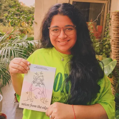 A published poet from our competition, beaming with her copy of the anthology 'voices from the edge'. This is the moment we work for.