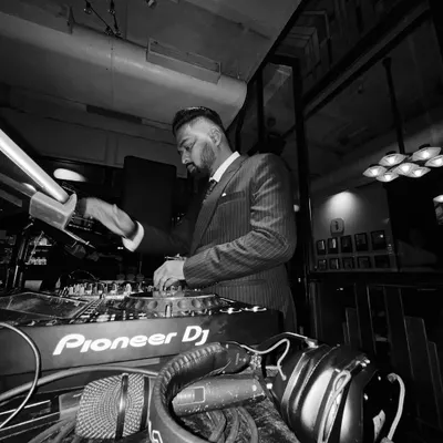 A black and white shot of me in a suit, focused on the mixer. This captures the classic, timeless feel I can bring to a formal event.